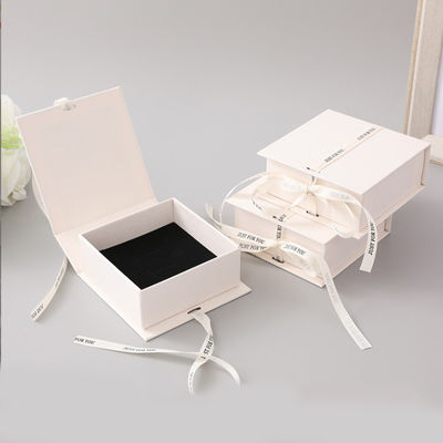 White Ribbon Logo Foldable Gift Box Make Up Clothes Accessories Rigid Paperboard With Glossy Lamination