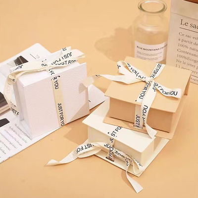 White Ribbon Logo Foldable Gift Box Make Up Clothes Accessories Rigid Paperboard With Glossy Lamination
