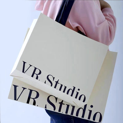 Custom Clothing Shopping Bags Packaging Luxury Ivory Board Kraft Paper Low Price  Shopping Gift Bag Custom Logo